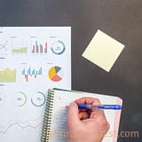 Person Writing On Notebook