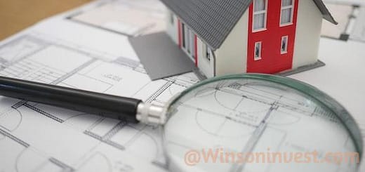 white and red wooden house beside grey framed magnifying glass
